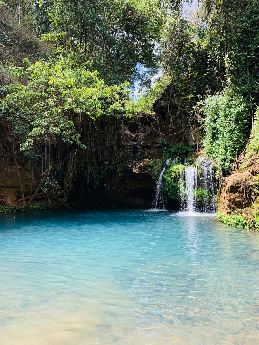 A turquoise waterfall pool in Western Kenya — the home we carry with us