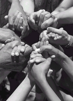 Many hands joined together in a circle — unity